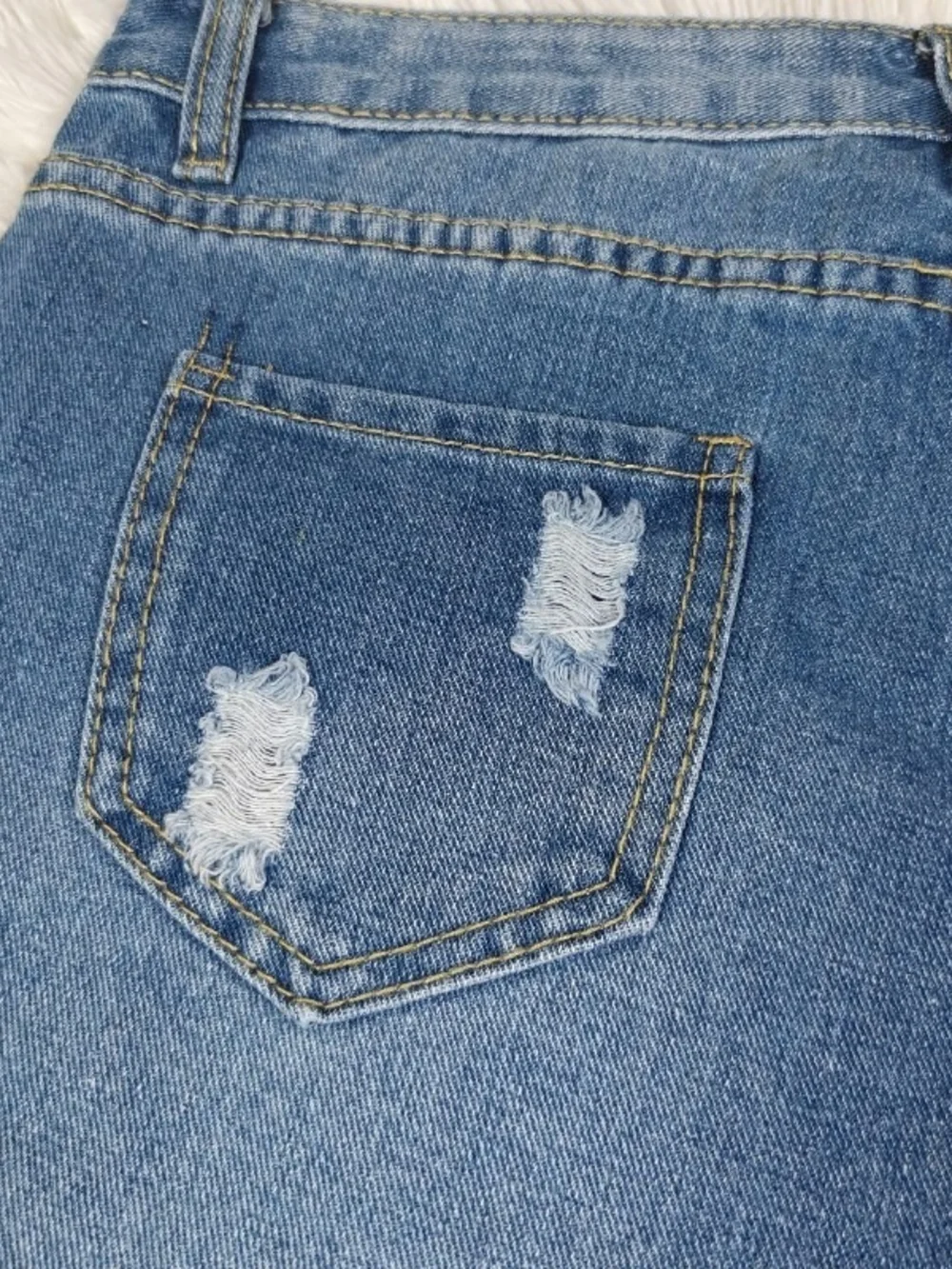 Distressed Blue Denim Shorts with Champion Patch